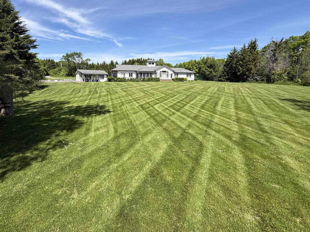 Large striped lawn in front of a country estate